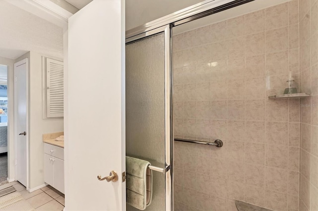 bathroom with tile patterned flooring, vanity, and a shower with shower door