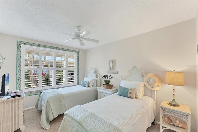 carpeted bedroom with a textured ceiling and ceiling fan