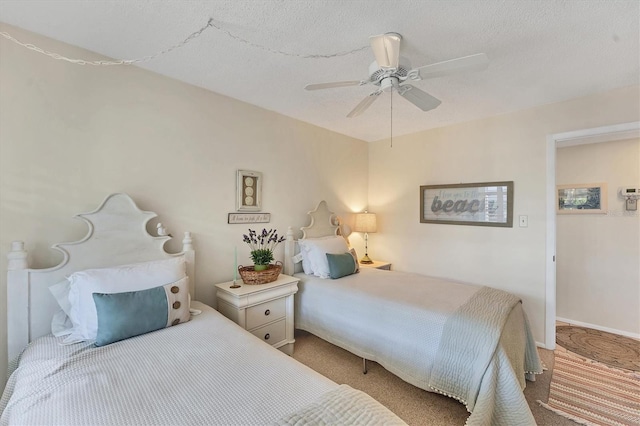 carpeted bedroom with a textured ceiling and ceiling fan