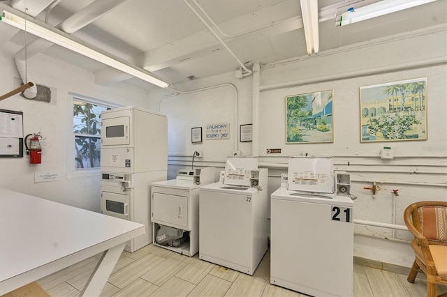 washroom featuring stacked washer / drying machine and washing machine and clothes dryer