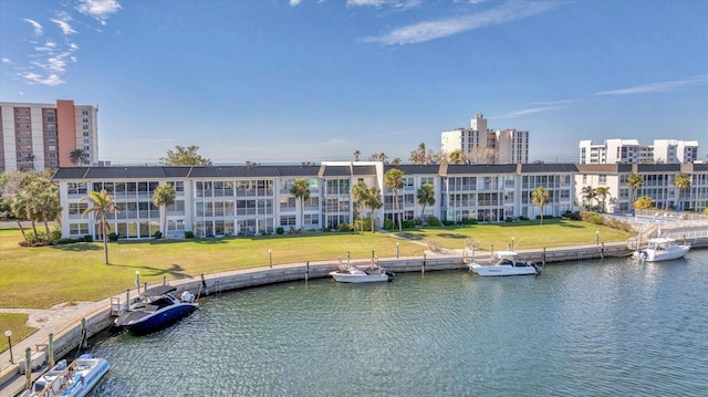 view of dock featuring a water view and a yard