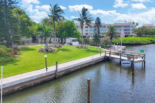 dock area featuring a water view and a yard