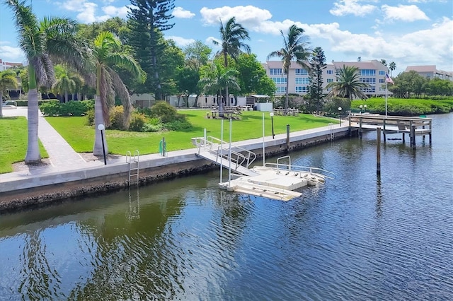 dock area with a yard and a water view