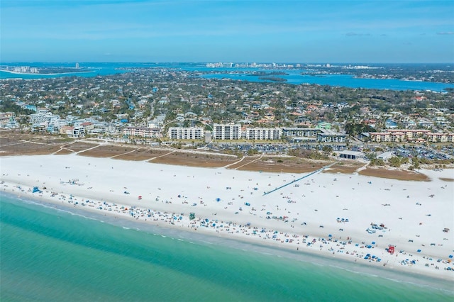 drone / aerial view featuring a water view and a beach view