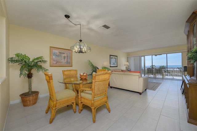 tiled dining area featuring an inviting chandelier