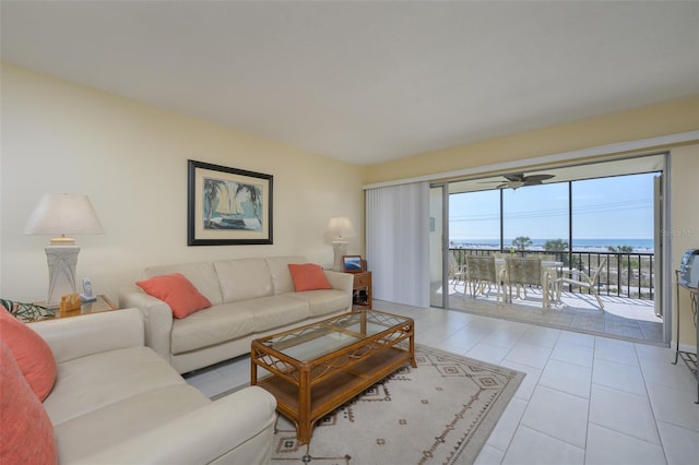 living room featuring a water view and light tile patterned floors