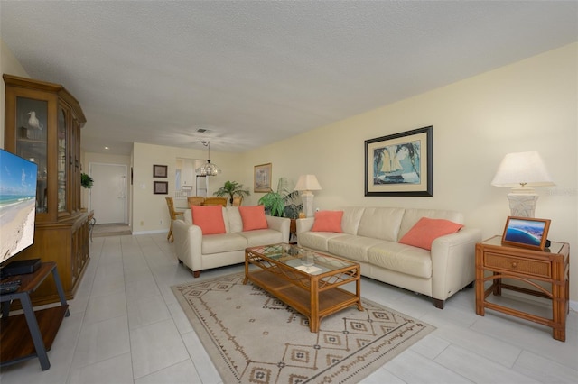 living room featuring a textured ceiling and light tile patterned floors