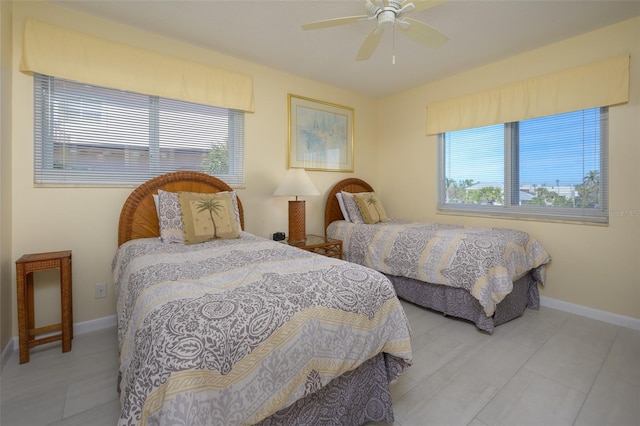 bedroom featuring multiple windows and ceiling fan