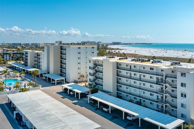 bird's eye view with a water view and a beach view