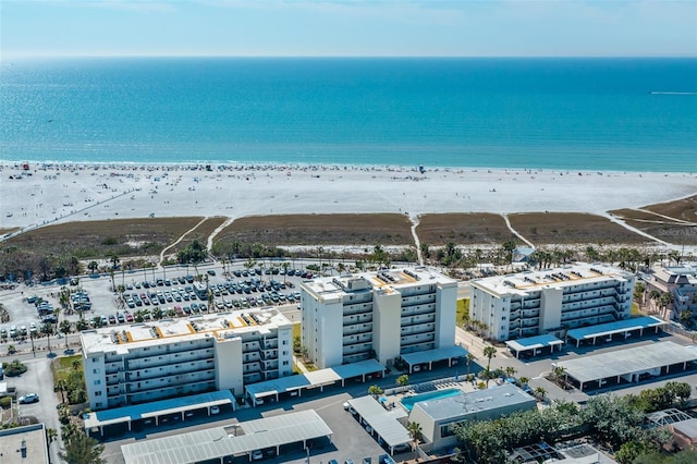 drone / aerial view with a water view and a beach view