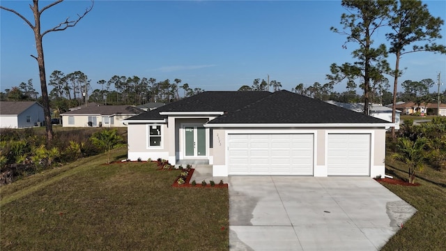 view of front of property with a garage and a front lawn