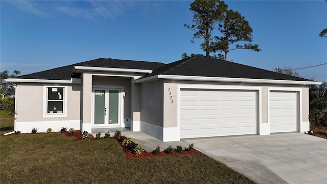 view of front of property featuring a garage and a front yard