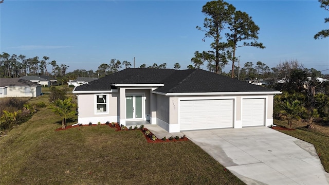 view of front of home with a garage and a front lawn