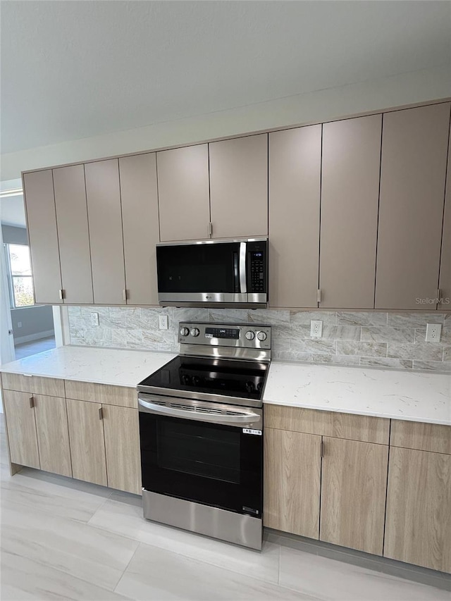 kitchen featuring tasteful backsplash, stainless steel appliances, and light brown cabinets