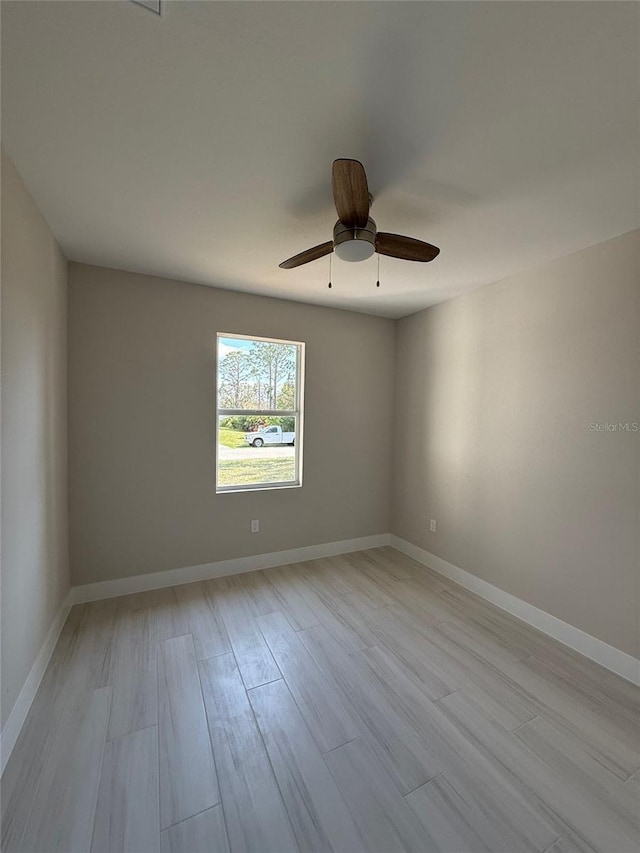 spare room with ceiling fan and light hardwood / wood-style flooring