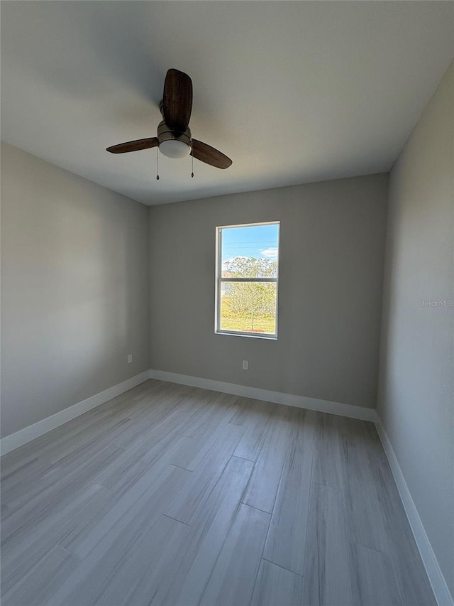 empty room featuring ceiling fan and light wood-type flooring