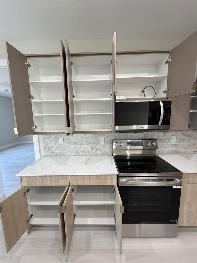 kitchen featuring decorative backsplash and appliances with stainless steel finishes