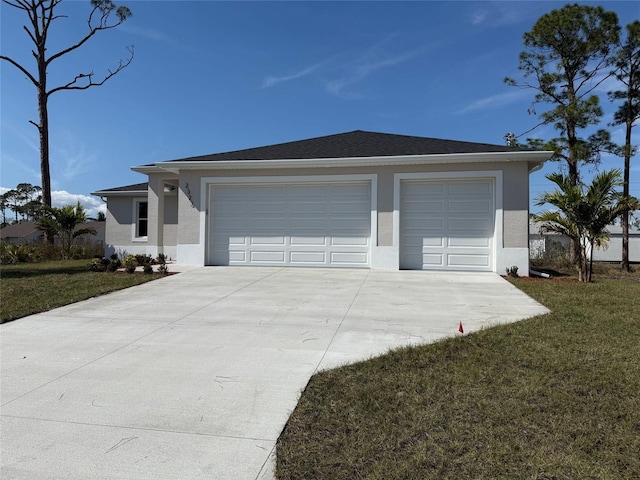 view of front of house featuring a garage and a front yard