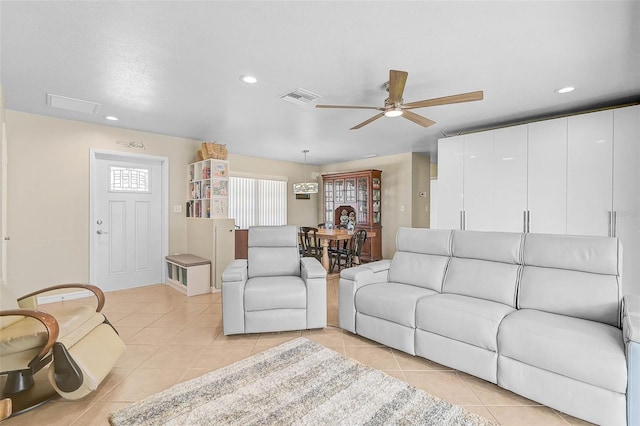 living room with ceiling fan and light tile patterned flooring