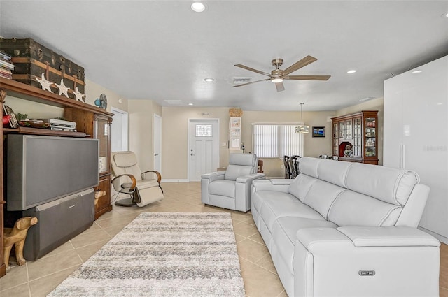 living room with ceiling fan and light tile patterned flooring