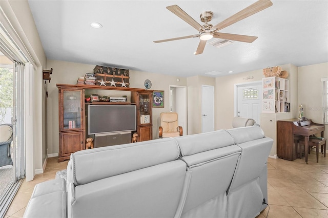 tiled living room with ceiling fan