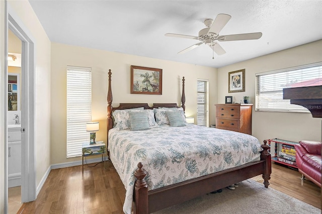 bedroom featuring hardwood / wood-style flooring, sink, and ceiling fan