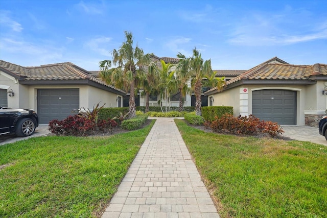 view of front of home with a garage and a front yard