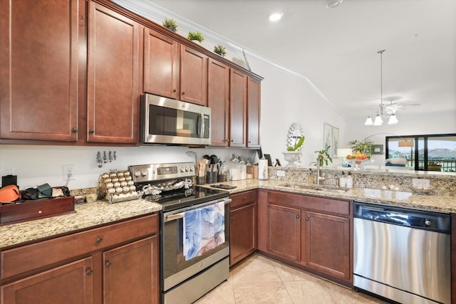 kitchen featuring light stone counters, sink, ornamental molding, and stainless steel appliances