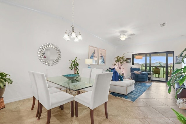 tiled dining area featuring ceiling fan with notable chandelier