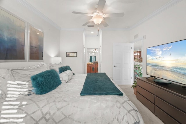 bedroom featuring ensuite bath, carpet floors, ornamental molding, and ceiling fan