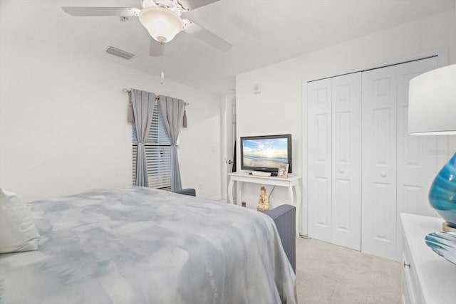 bedroom with light colored carpet, a closet, and ceiling fan