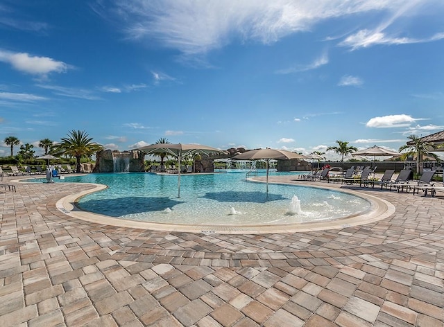 view of swimming pool with a patio and pool water feature