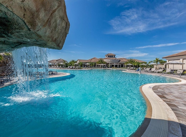 view of pool featuring pool water feature and a patio area