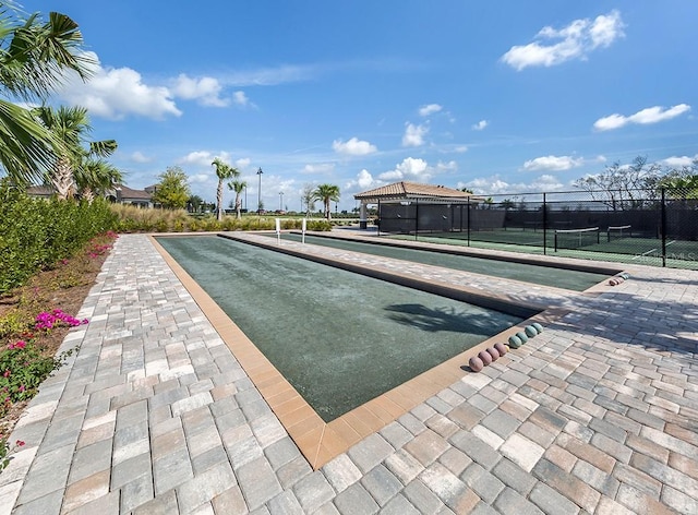 view of swimming pool featuring tennis court