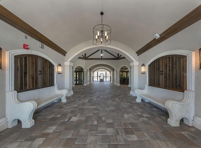 foyer featuring vaulted ceiling and a notable chandelier