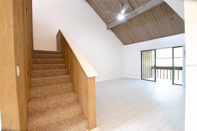 staircase featuring hardwood / wood-style floors, high vaulted ceiling, wood ceiling, ceiling fan, and beam ceiling