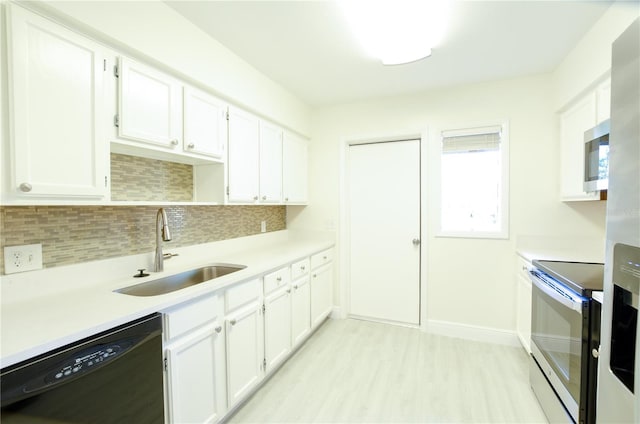 kitchen with white cabinetry, sink, and stainless steel appliances