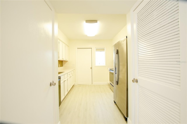 kitchen featuring white cabinetry, stainless steel appliances, and light hardwood / wood-style floors