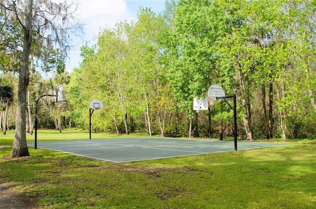 view of sport court with a lawn