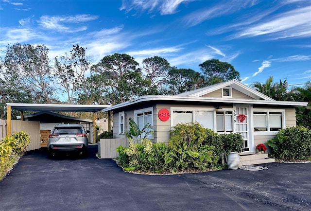 single story home featuring a carport