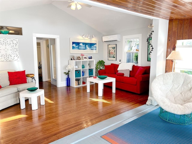 living room with lofted ceiling, an AC wall unit, dark hardwood / wood-style floors, and ceiling fan