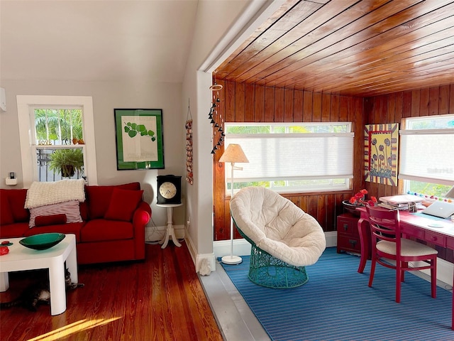 interior space featuring dark wood-type flooring, wooden ceiling, and wooden walls