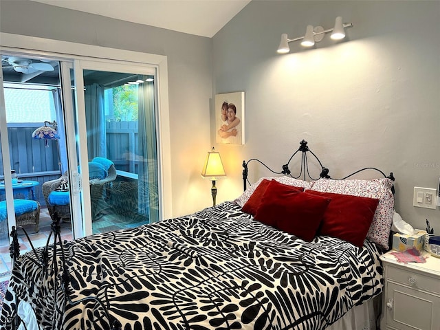 bedroom with lofted ceiling and access to outside