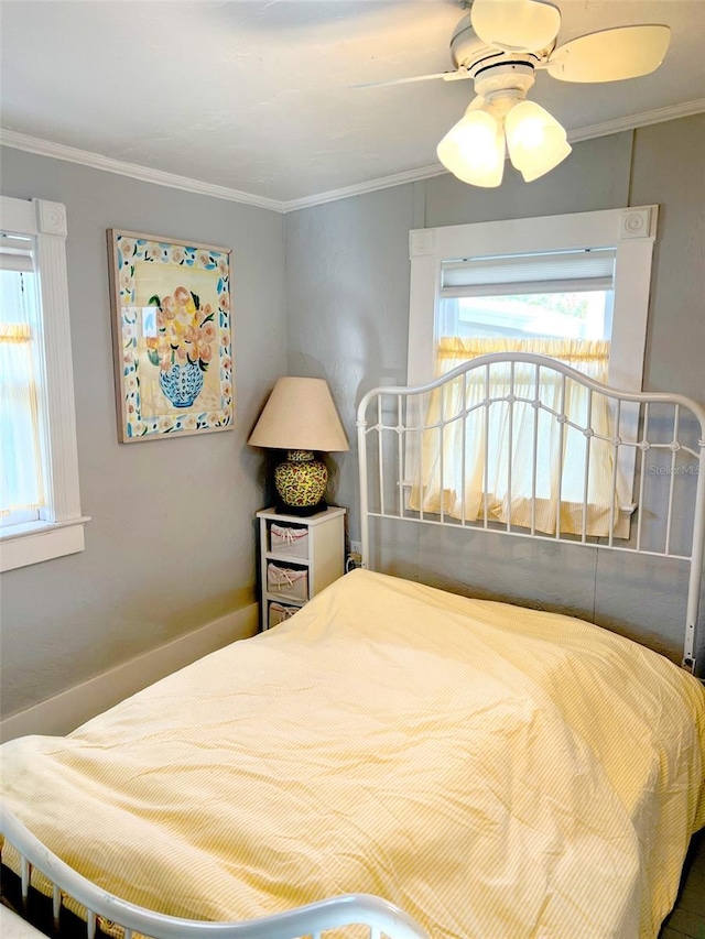 bedroom with multiple windows, ornamental molding, and ceiling fan