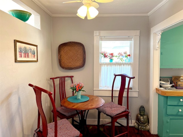 dining space with ornamental molding and ceiling fan