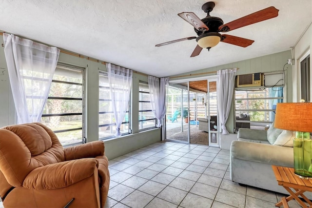 tiled living room with ceiling fan and a textured ceiling