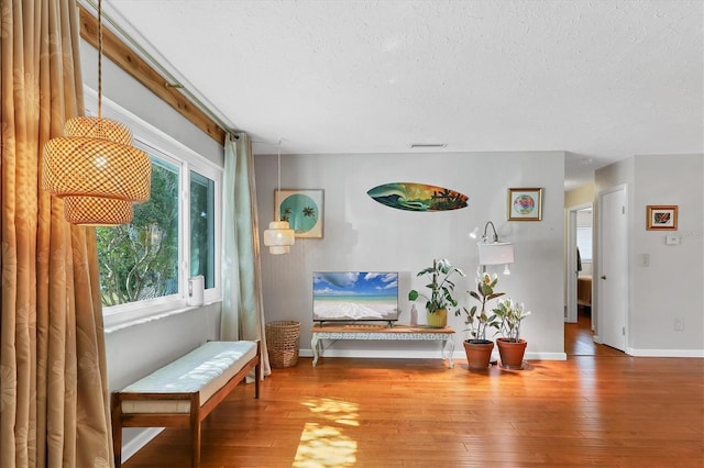 sitting room featuring hardwood / wood-style floors and a textured ceiling