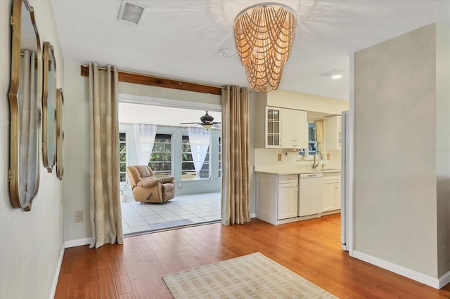 entryway featuring ceiling fan, sink, and light hardwood / wood-style floors