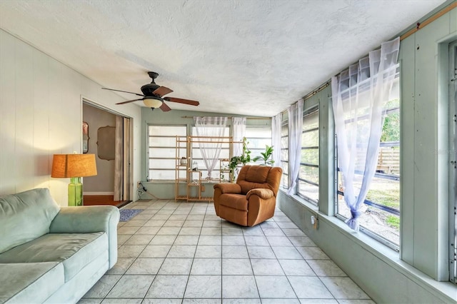 sunroom featuring ceiling fan