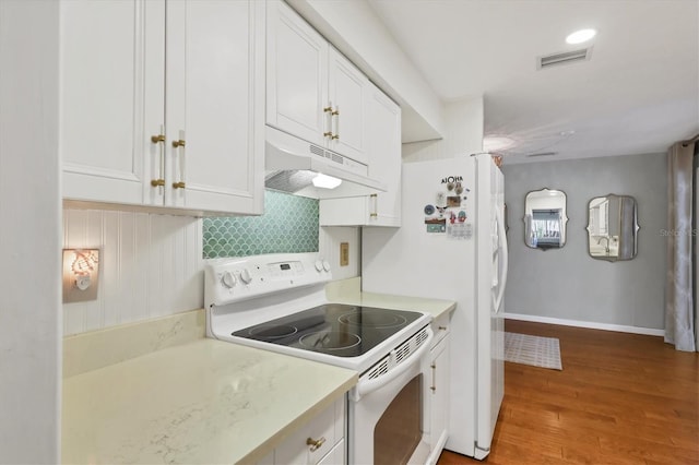 kitchen with electric stove, white cabinetry, and light wood-type flooring